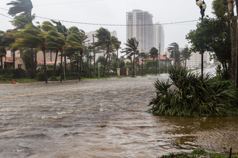 A flooded street after a hurricane in Florida, depicting the aftermath of the natural disaster and its impact on the local area.